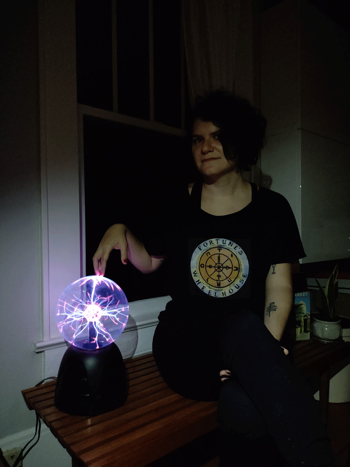 Marta Núñez Pouzols sitting beside a plasma globe